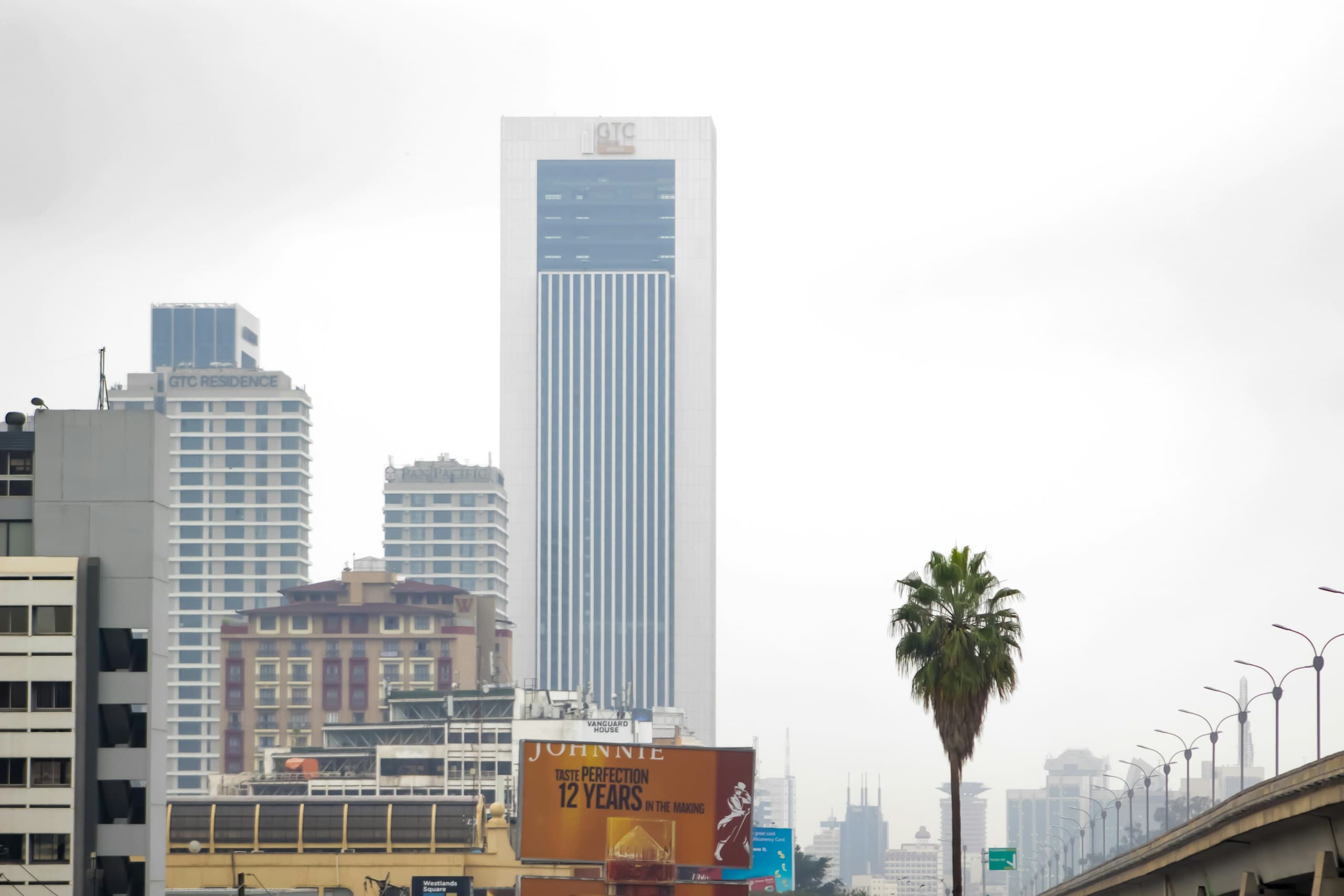 Office towers in Westlands, Nairobi, against a pale sky
